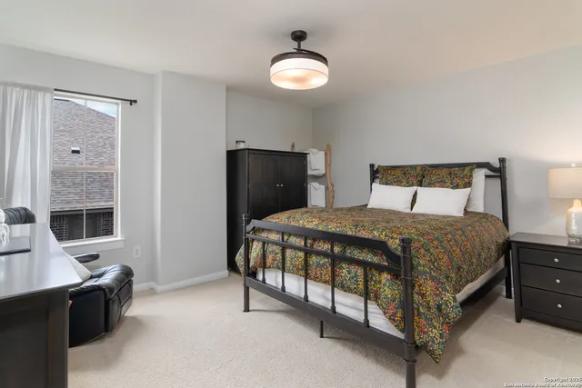 a bedroom with a bed and a window