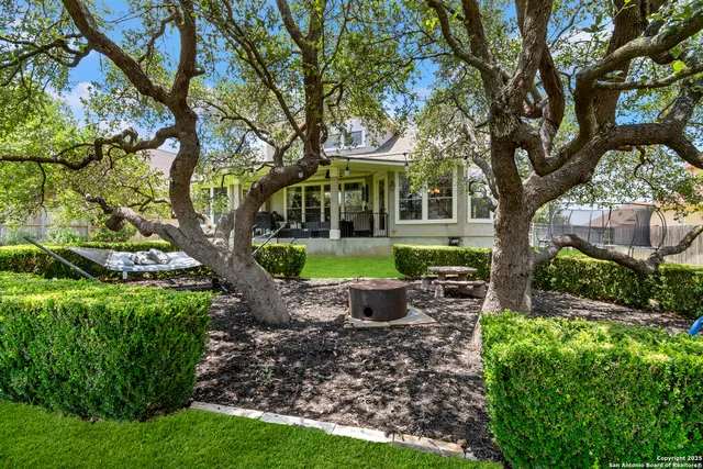a view of a house with backyard and sitting area