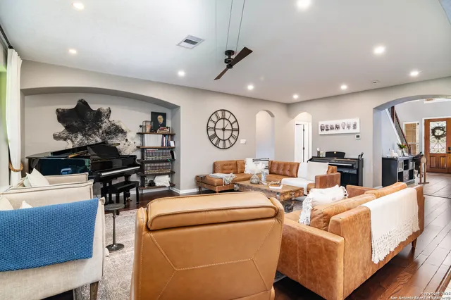 a living room with furniture and wooden floor