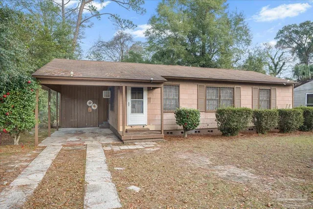 a front view of a house with a garden and porch