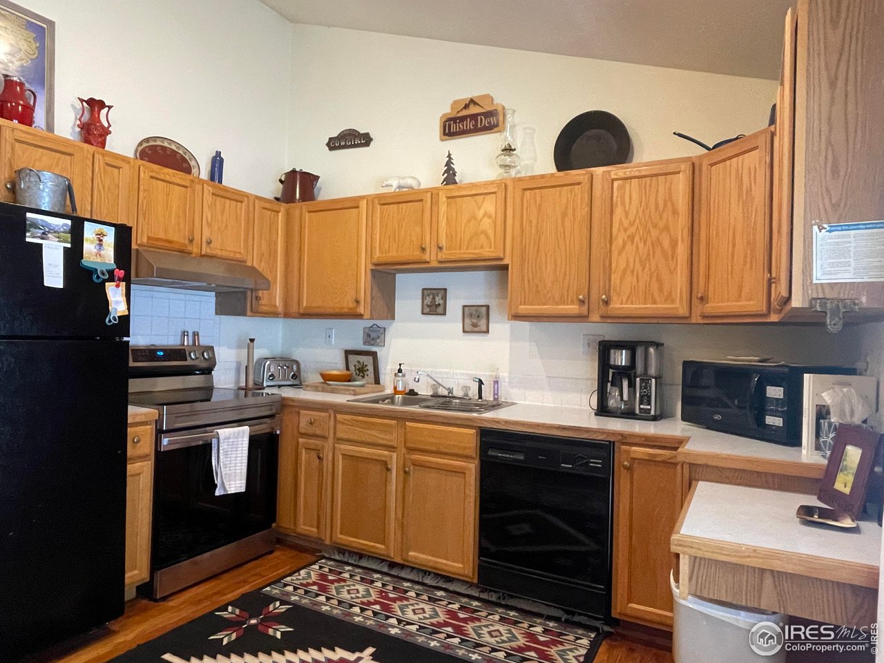 44 Riverside Lane Ward, CO 80481 - Photo 11 of 33 a kitchen with stainless steel appliances granite countertop a sink a stove and cabinets