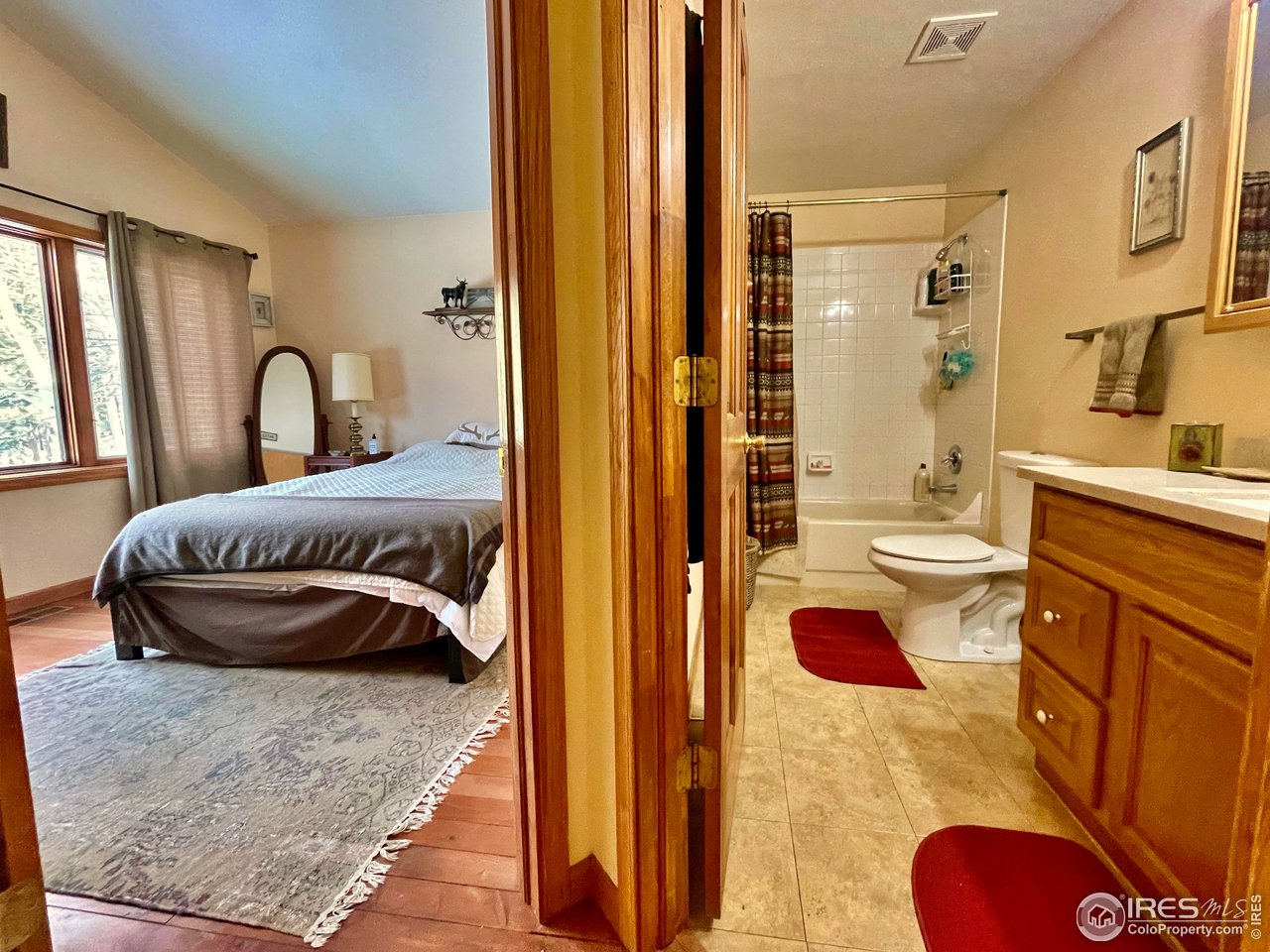 44 Riverside Lane Ward, CO 80481 - Photo 12 of 33 a bedroom with a bed and a dresser