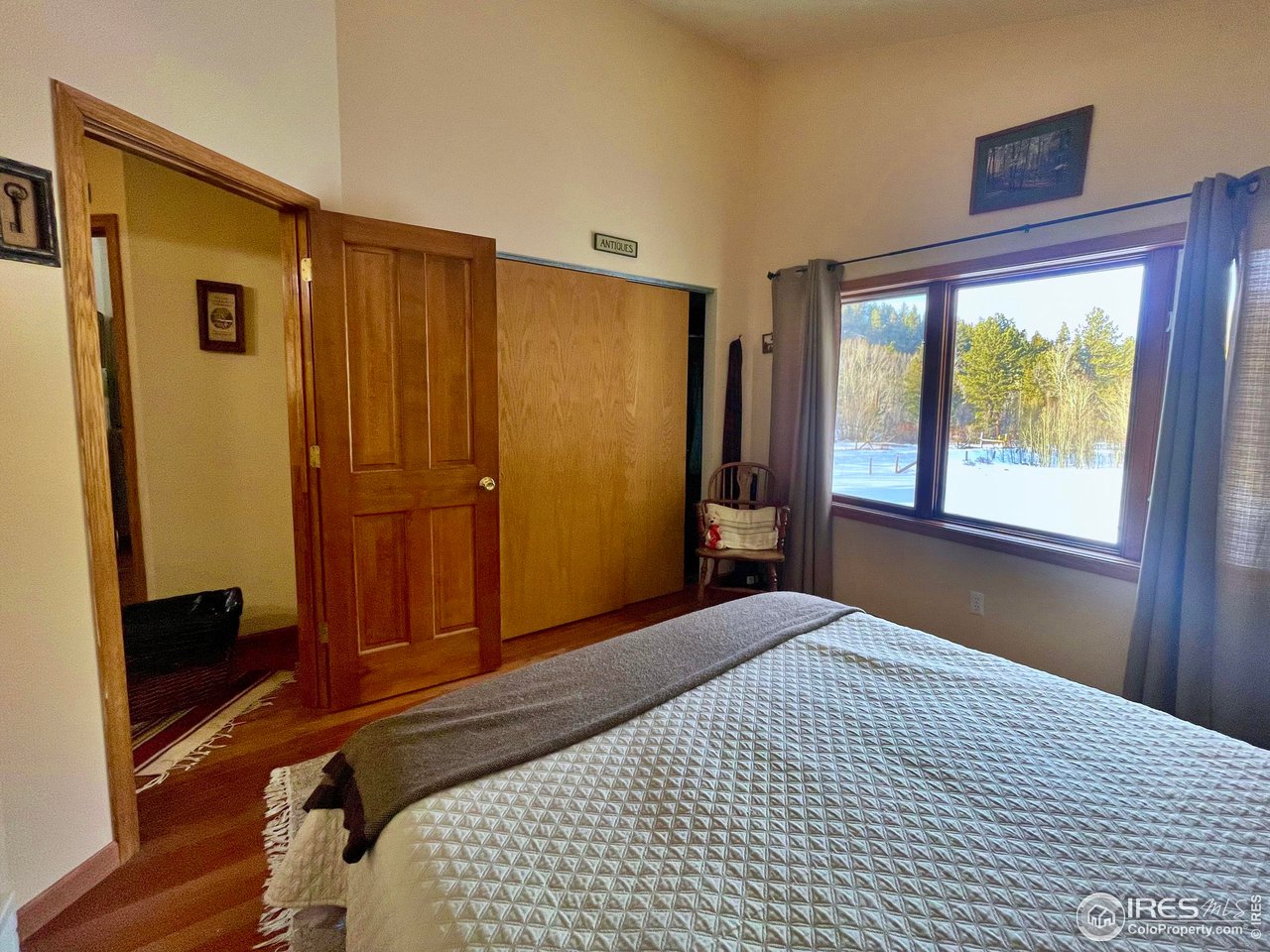 44 Riverside Lane Ward, CO 80481 - Photo 13 of 33 a bedroom with a bed and a mirror