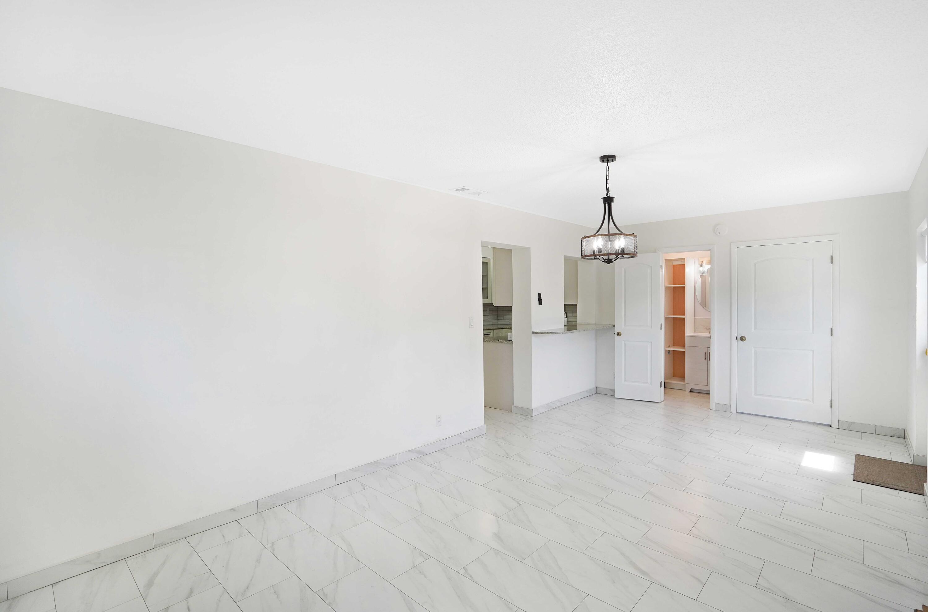 5100 Northeast 22nd Avenue Lighthouse Point, FL 33064 - Photo 12 of 31 a view of a kitchen with a sink and a chandelier