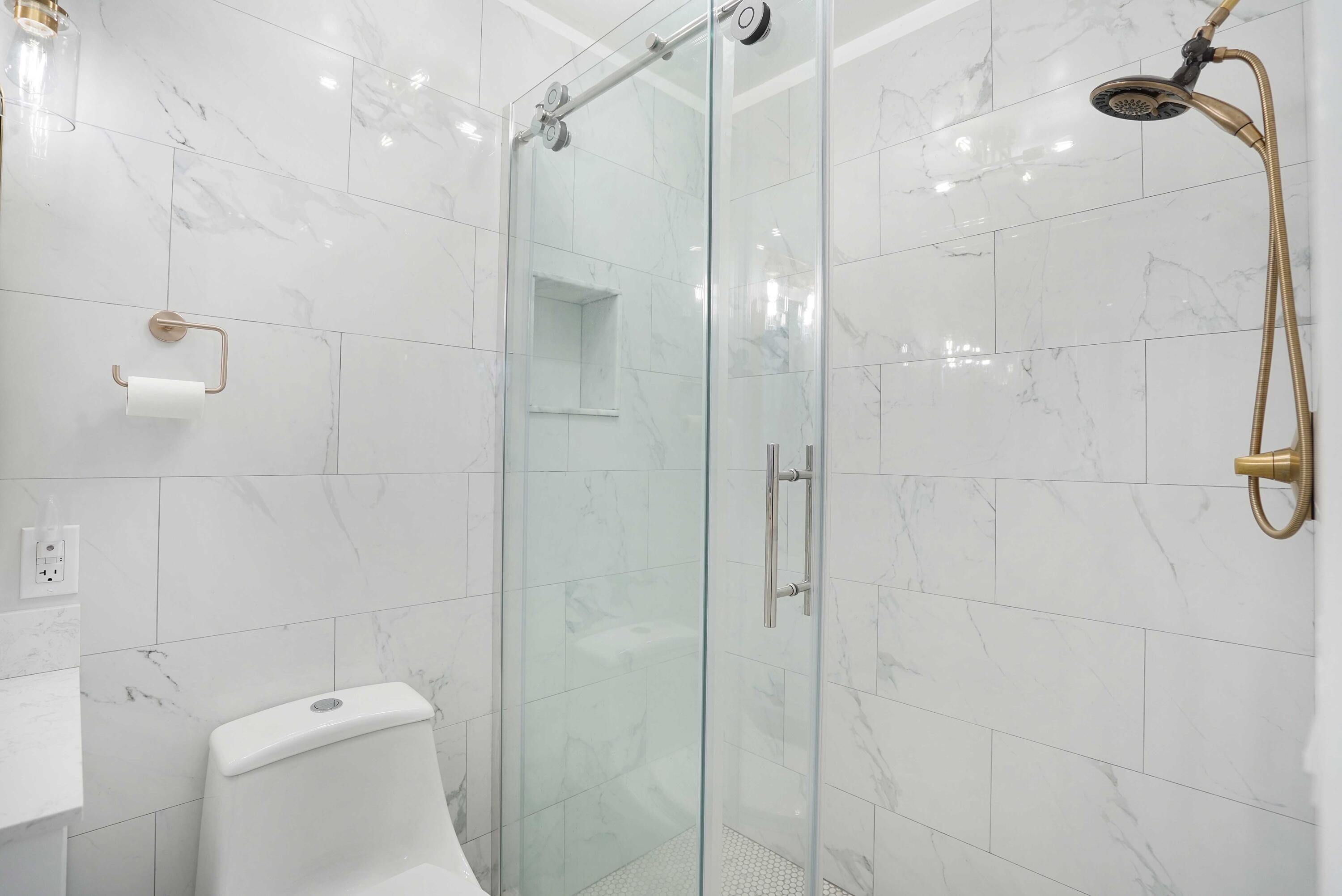 5100 Northeast 22nd Avenue Lighthouse Point, FL 33064 - Photo 15 of 31 a bathroom with a shower and toilet