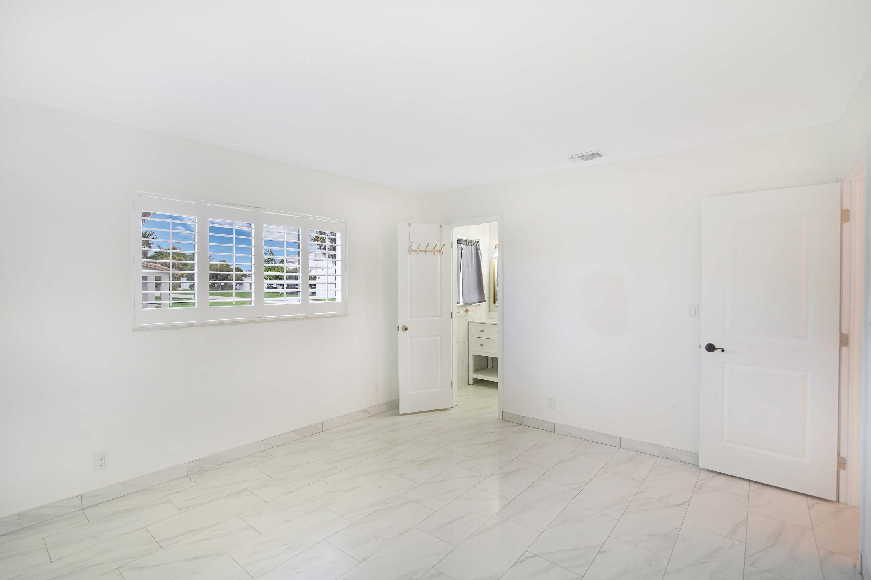 5100 Northeast 22nd Avenue Lighthouse Point, FL 33064 - Photo 18 of 31 an empty room with windows