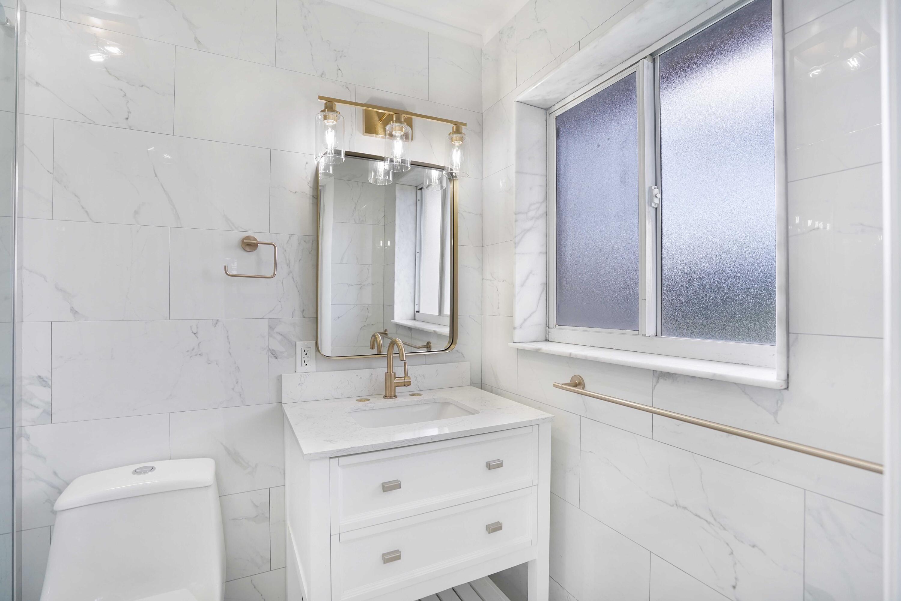 5100 Northeast 22nd Avenue Lighthouse Point, FL 33064 - Photo 21 of 31 a bathroom with a sink a toilet and shower