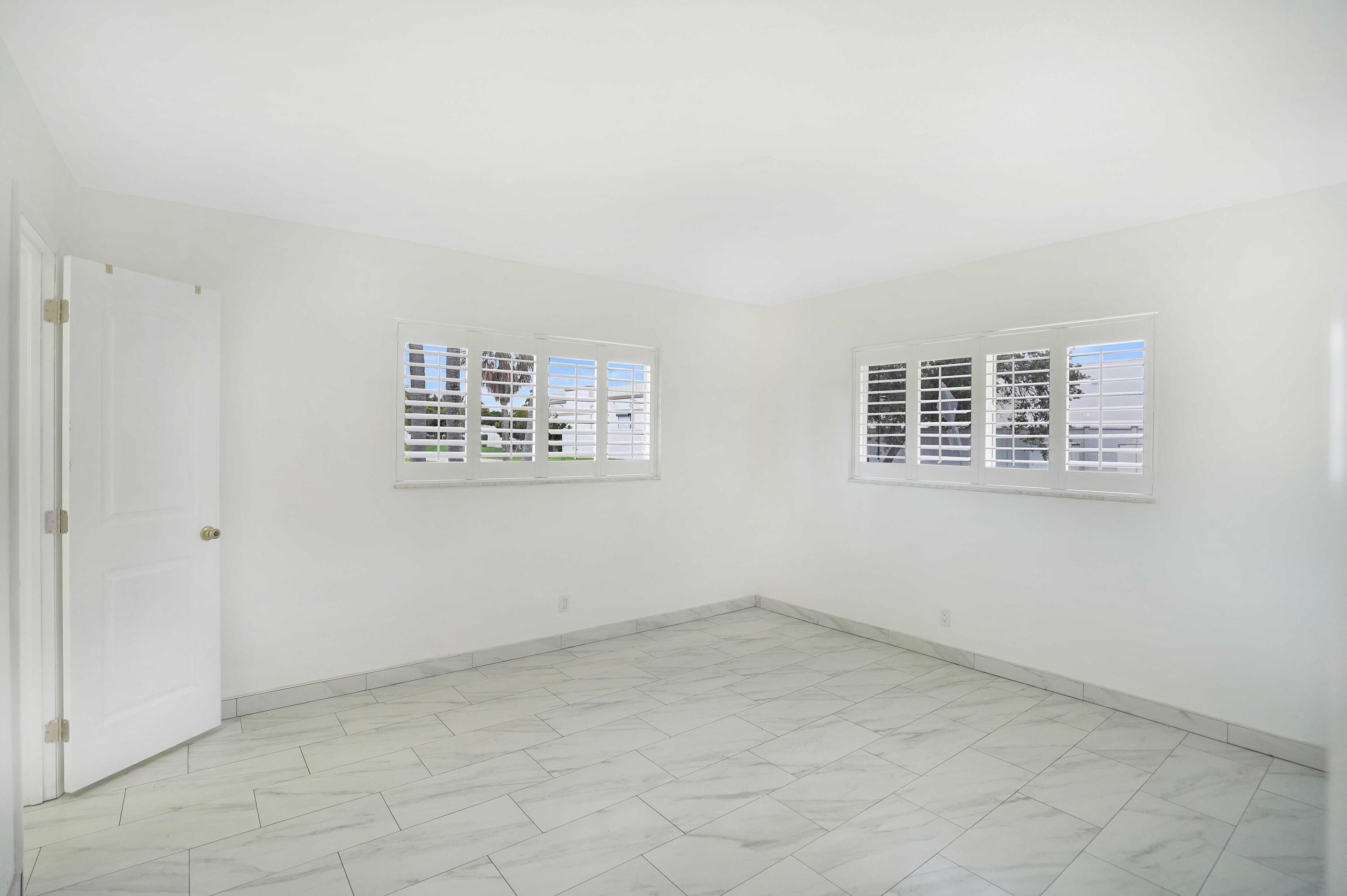 5100 Northeast 22nd Avenue Lighthouse Point, FL 33064 - Photo 23 of 31 an empty room with windows