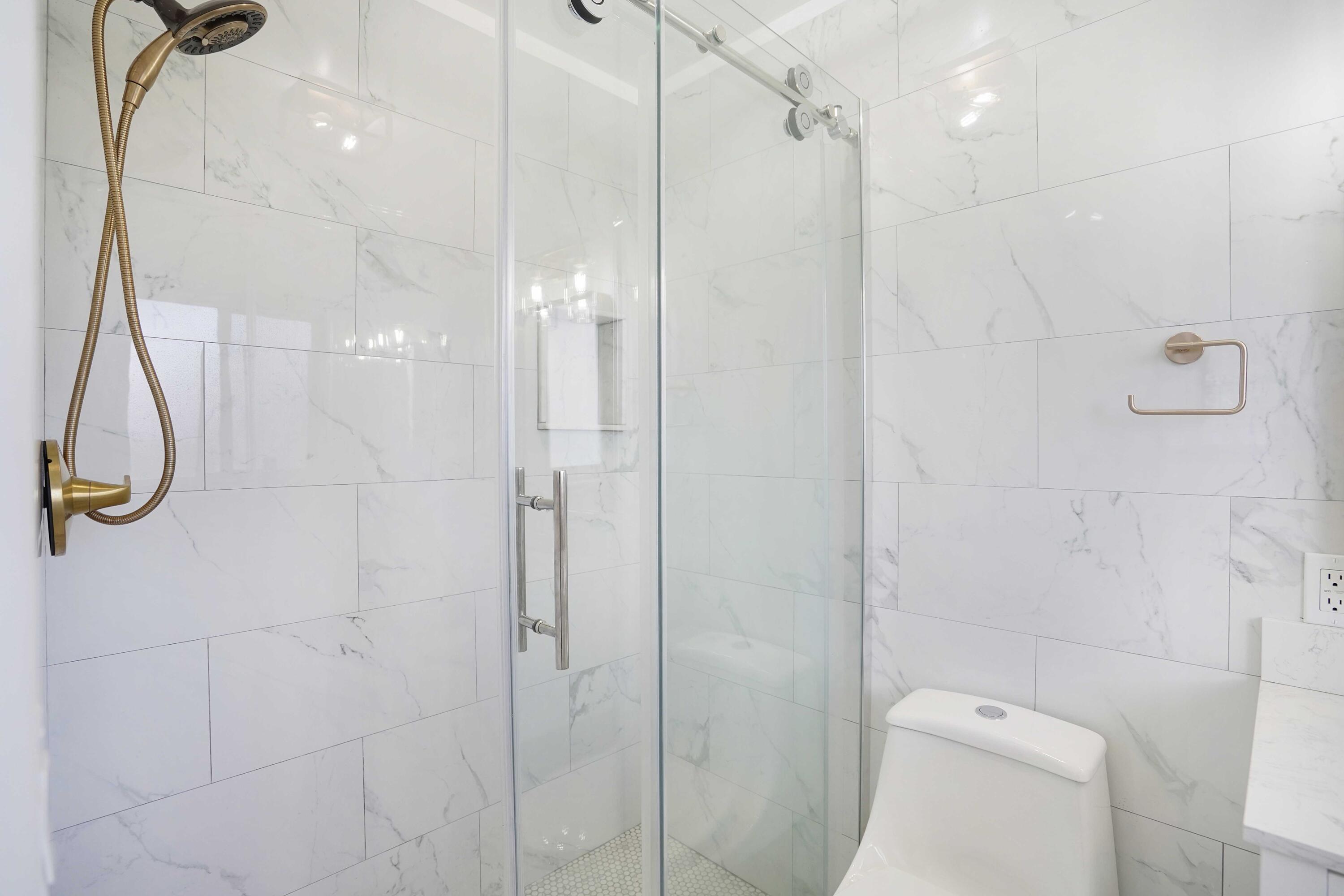 5100 Northeast 22nd Avenue Lighthouse Point, FL 33064 - Photo 25 of 31 a bathroom with a shower and toilet