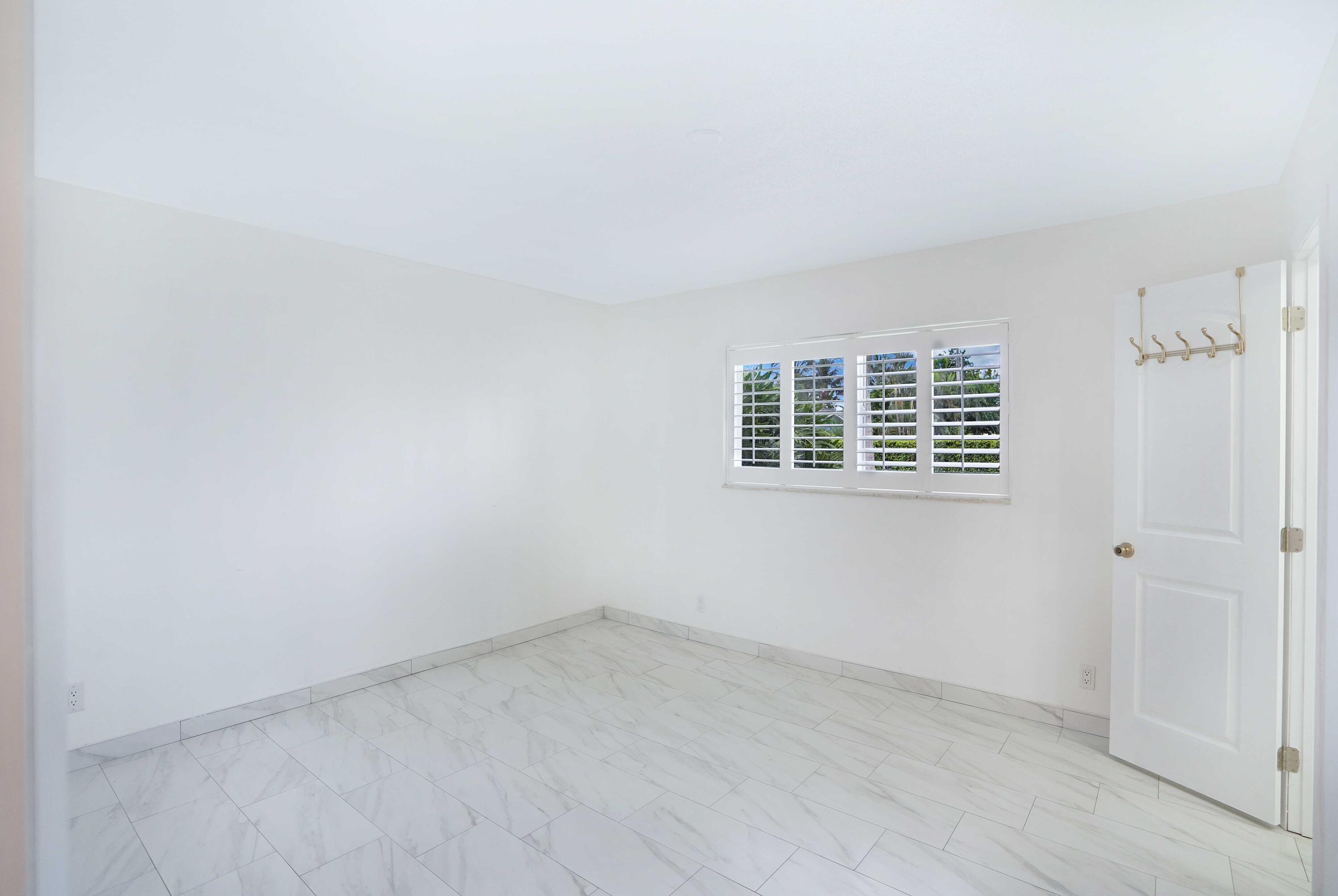 5100 Northeast 22nd Avenue Lighthouse Point, FL 33064 - Photo 7 of 31 an empty room with a window