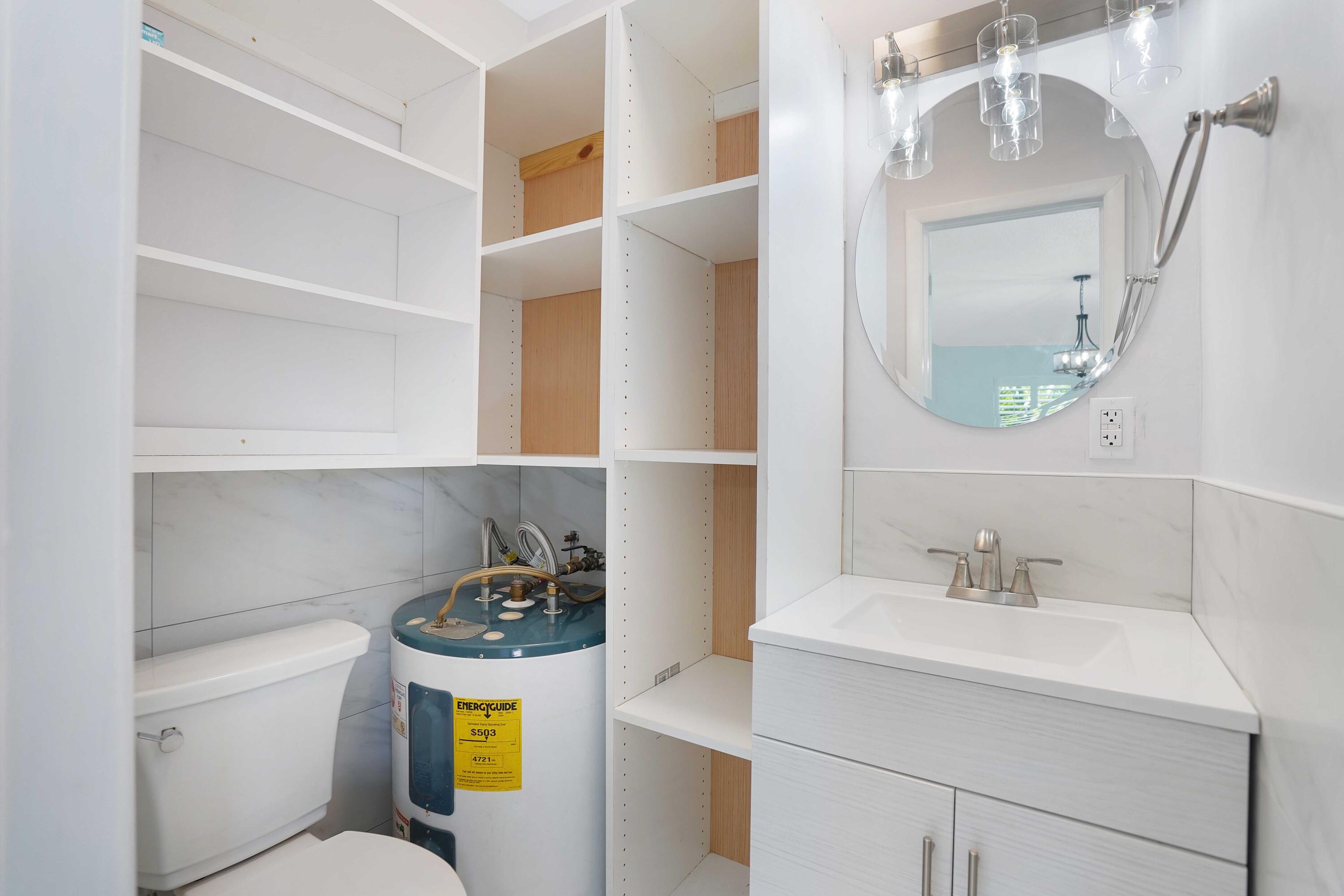 5100 Northeast 22nd Avenue Lighthouse Point, FL 33064 - Photo 8 of 31 a bathroom with a sink a vanity and a toilet