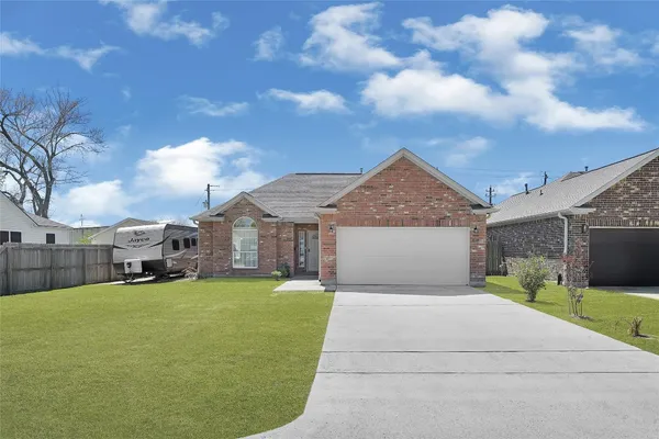 a view of a house with a big yard and a large tree