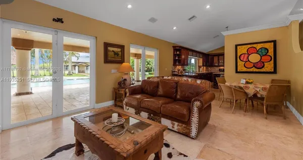a living room with furniture and large windows