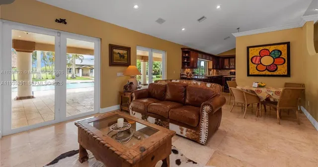 a living room with furniture and large windows