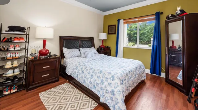 a bedroom with a bed and a dresser in it