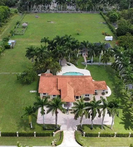 an aerial view of a house with a yard