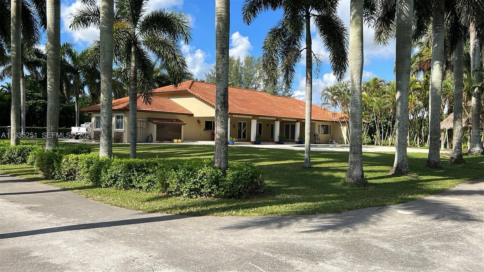 19701 Southwest 197th Avenue Miami, FL 33187 - Photo 2 of 19 front view of a house with a garden