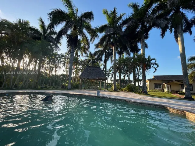 a swimming pool with outdoor seating and yard