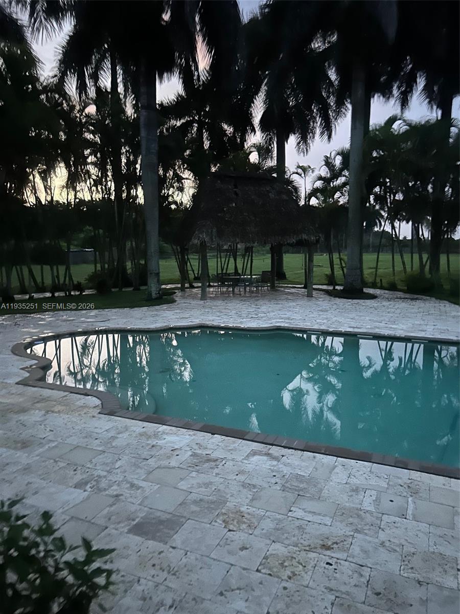 19701 Southwest 197th Avenue Miami, FL 33187 - Photo 6 of 19 a front view of a house with a yard