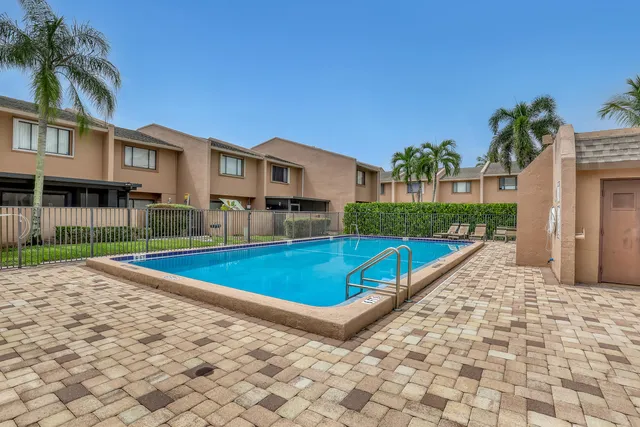 a view of swimming pool with a lounge chairs