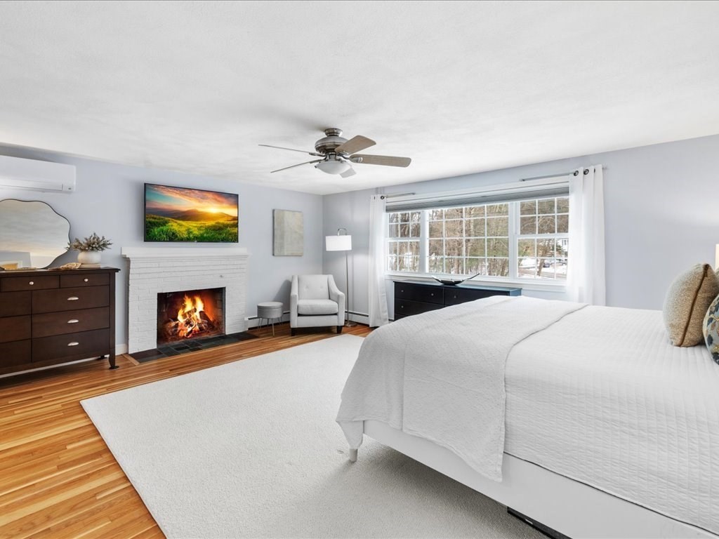 1 Scott Street Medfield, MA 02052 - Photo 21 of 42 a bedroom with a bed a fireplace and a fireplace
