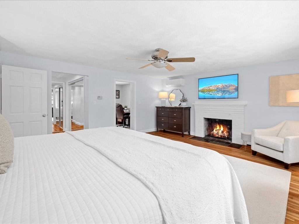 1 Scott Street Medfield, MA 02052 - Photo 23 of 42 a spacious bedroom with a bed and a fireplace