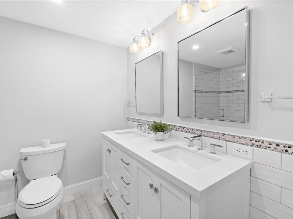 1 Scott Street Medfield, MA 02052 - Photo 27 of 42 a bathroom with a toilet sink and mirror