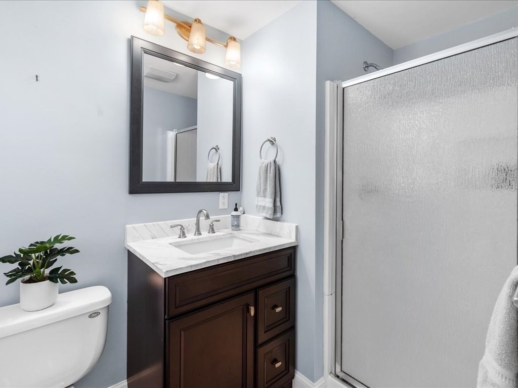1 Scott Street Medfield, MA 02052 - Photo 37 of 42 a bathroom with a toilet a sink and a mirror