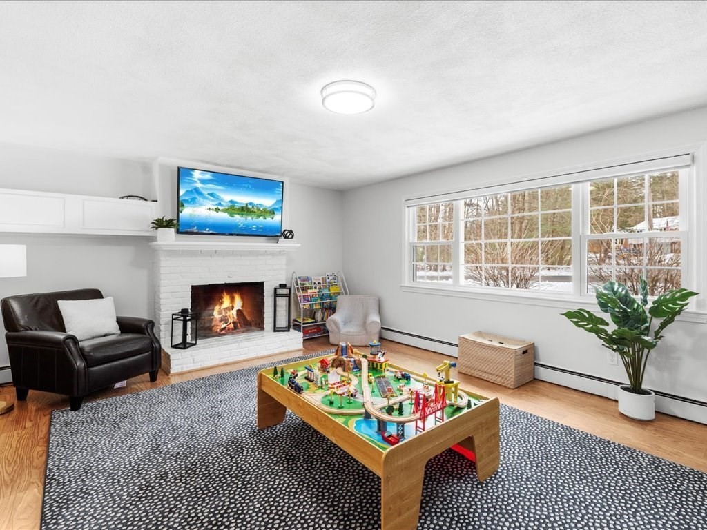 1 Scott Street Medfield, MA 02052 - Photo 5 of 42 a living room with furniture floor to ceiling window and a fireplace