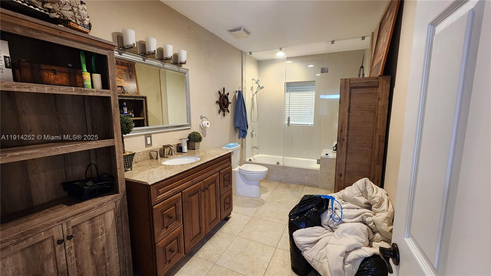 7945 Sunset Drive Miami, FL 33143 - Photo 17 of 28 a spacious bathroom with a sink a toilet and shower