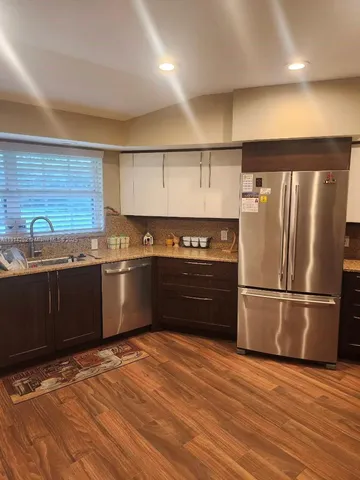 a kitchen with a refrigerator and a stove