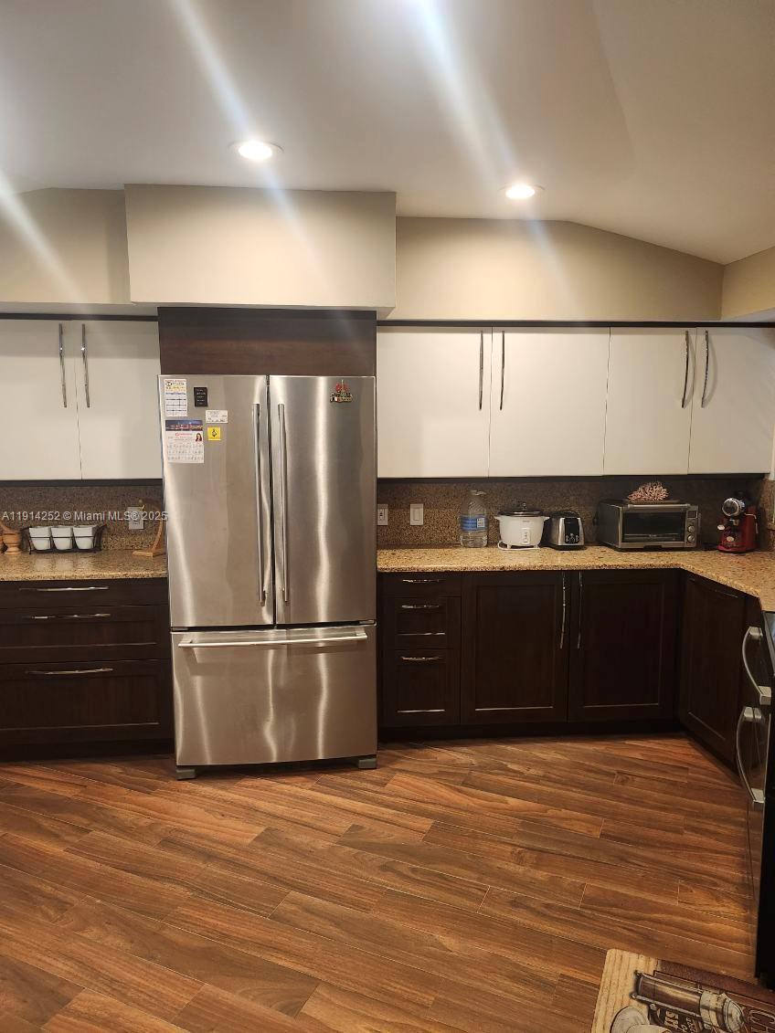 7945 Sunset Drive Miami, FL 33143 - Photo 23 of 28 a kitchen with a refrigerator and a stove