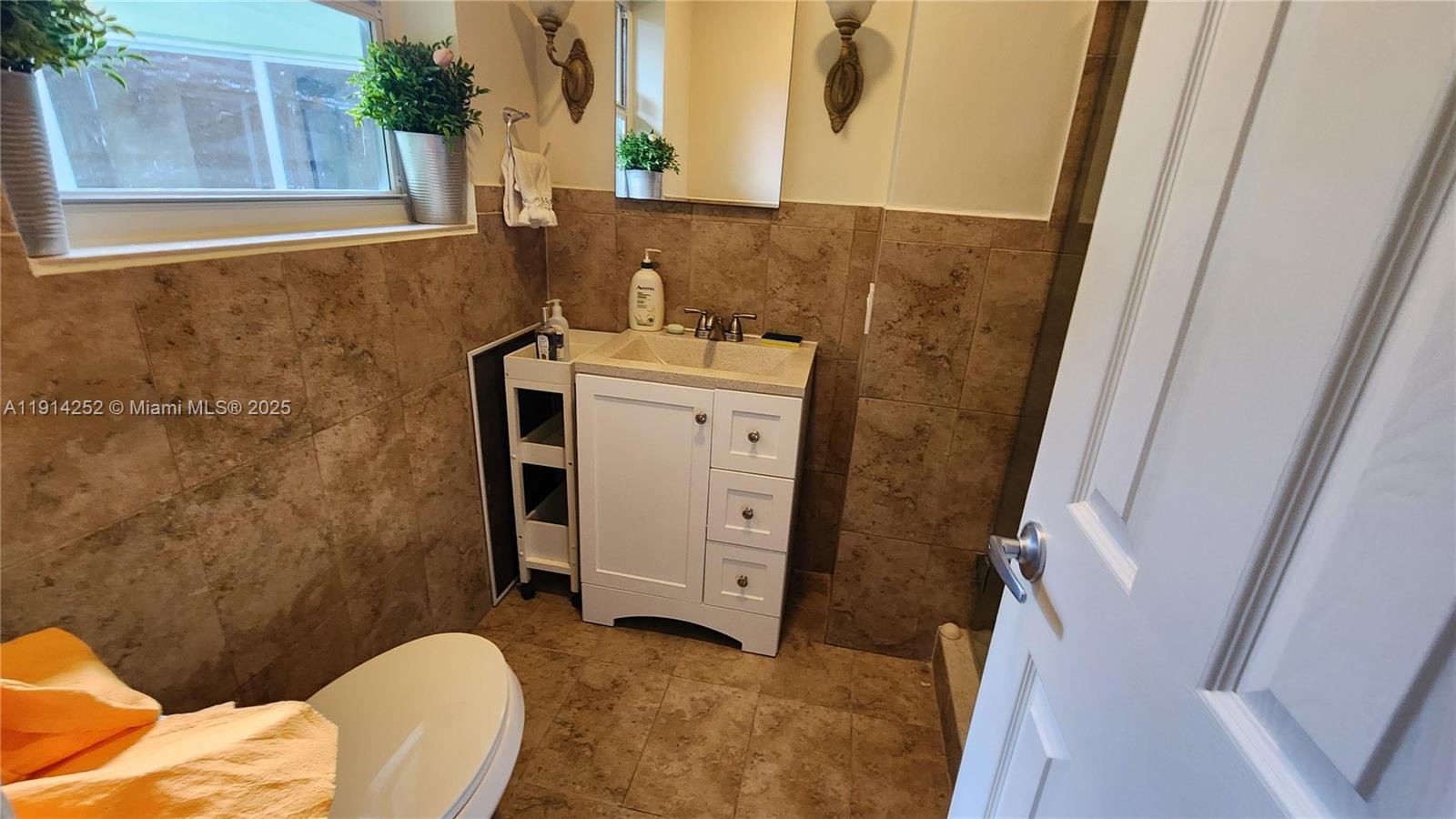 7945 Sunset Drive Miami, FL 33143 - Photo 6 of 28 a bathroom with a sink and a mirror