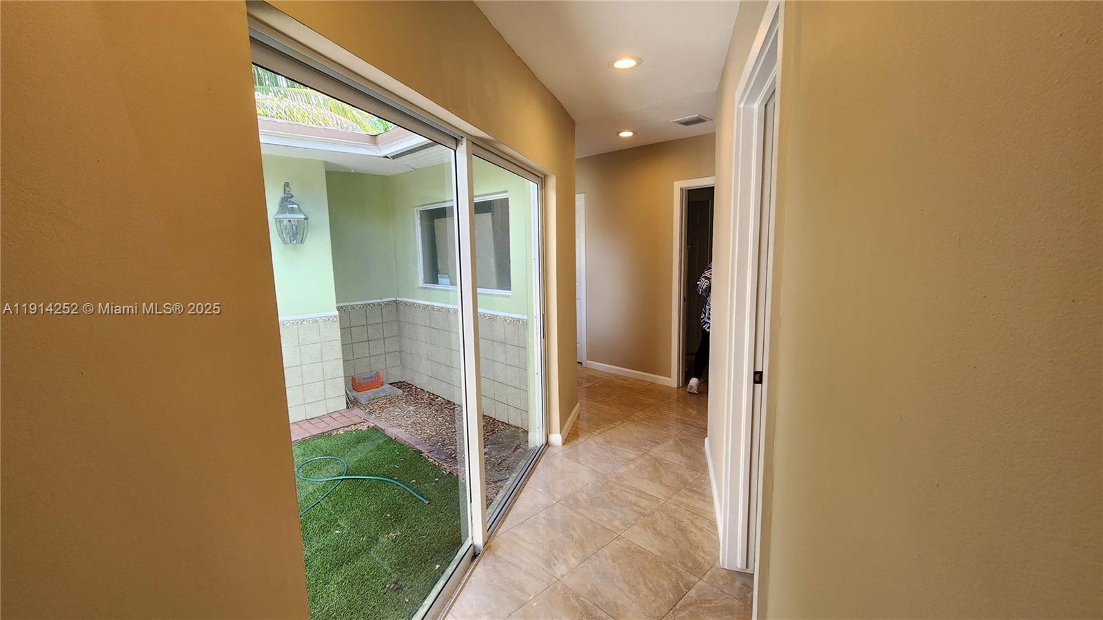 7945 Sunset Drive Miami, FL 33143 - Photo 9 of 28 a view of a hallway with wooden floor and a bathroom