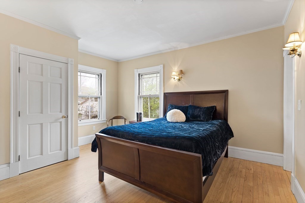 49-53 Appleton Street, Unit 7 Arlington, MA 02476 - Photo 11 of 21 a bed sitting in a bedroom next to a window