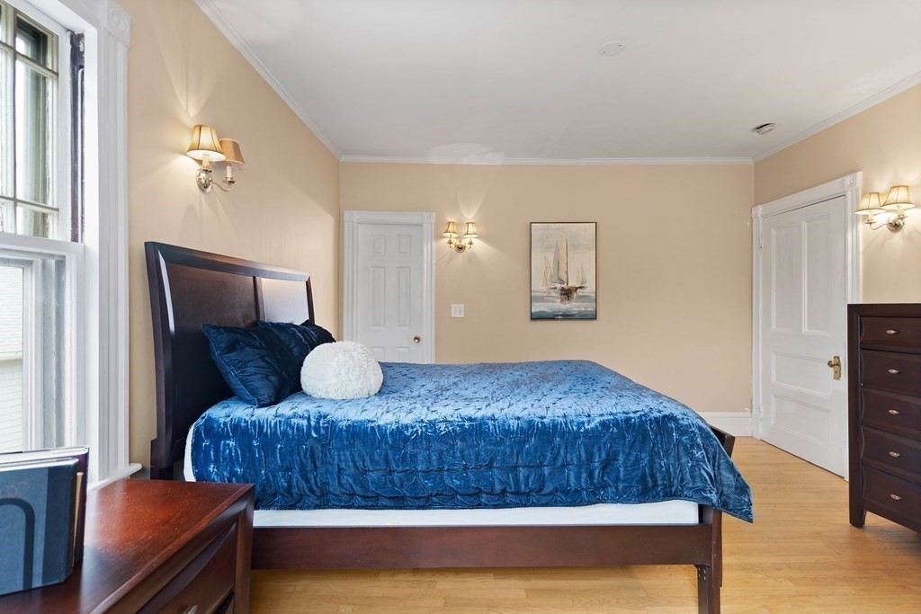 49-53 Appleton Street, Unit 7 Arlington, MA 02476 - Photo 12 of 21 a bedroom with a bed and dresser with mirror
