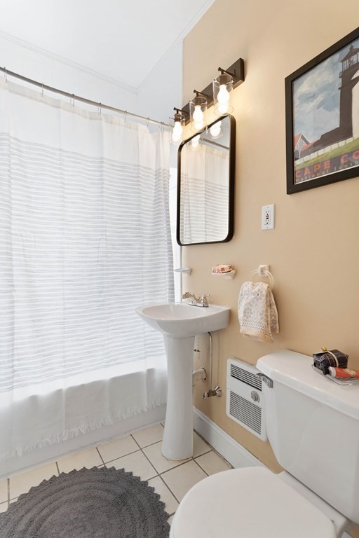 49-53 Appleton Street, Unit 7 Arlington, MA 02476 - Photo 13 of 21 a bathroom with a toilet sink and mirror