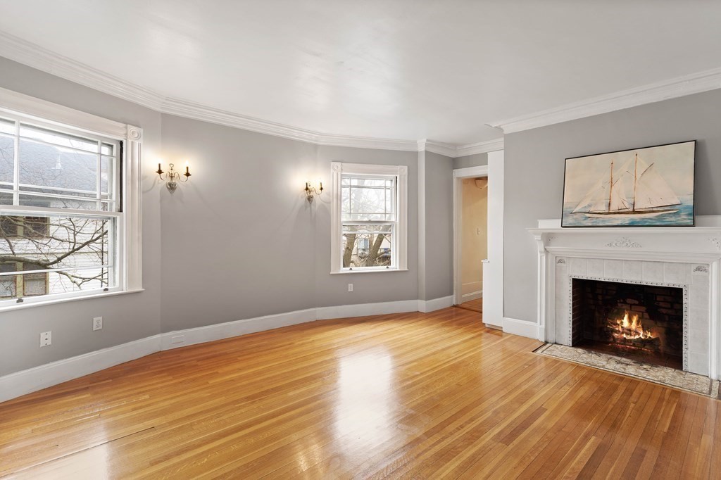 49-53 Appleton Street, Unit 7 Arlington, MA 02476 - Photo 3 of 21 a view of an empty room with window and fire place