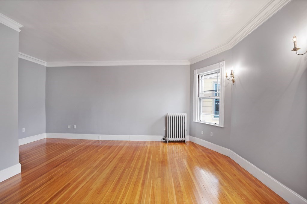49-53 Appleton Street, Unit 7 Arlington, MA 02476 - Photo 5 of 21 wooden floor in an empty room with a window