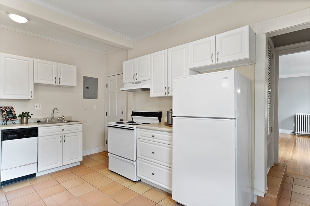 49-53 Appleton Street, Unit 7 Arlington, MA 02476 - Photo 9 of 21 a white refrigerator freezer sitting in a kitchen