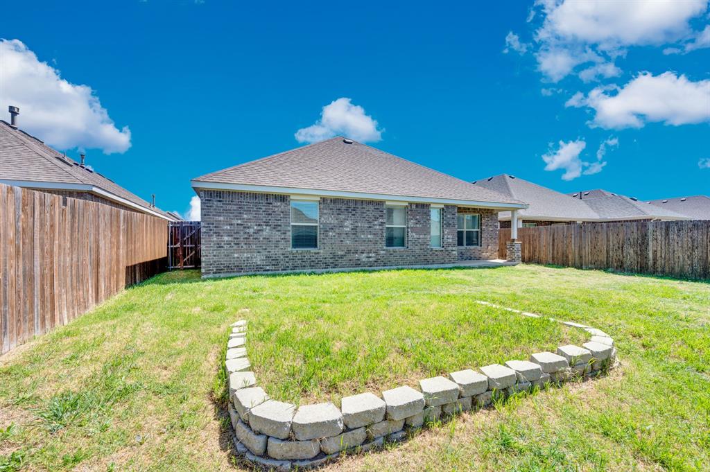 2609 Centurion Road Glenn Heights, TX 75154 - Photo 6 of 29 Rear view of house featuring brick siding, a patio area, a fenced backyard, and roof with shingles