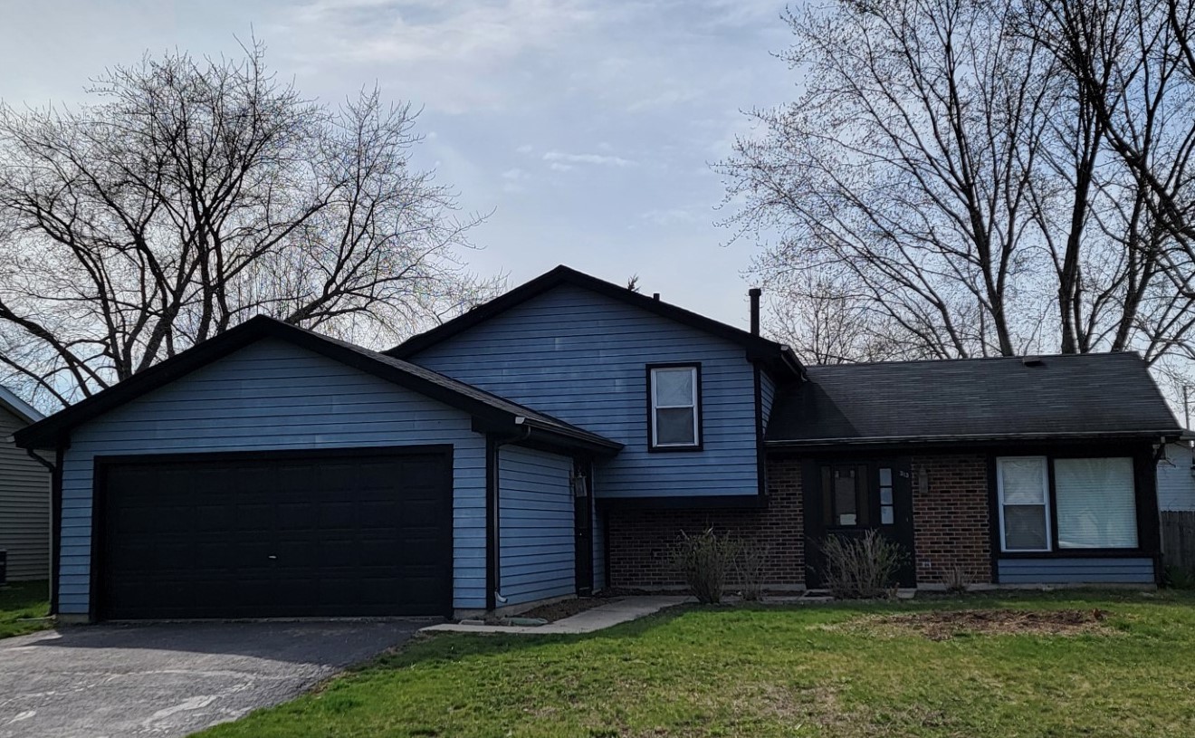 313 Dean Circle Bolingbrook, IL 60440 - Photo 1 of 15 a front view of a house with a yard and garage