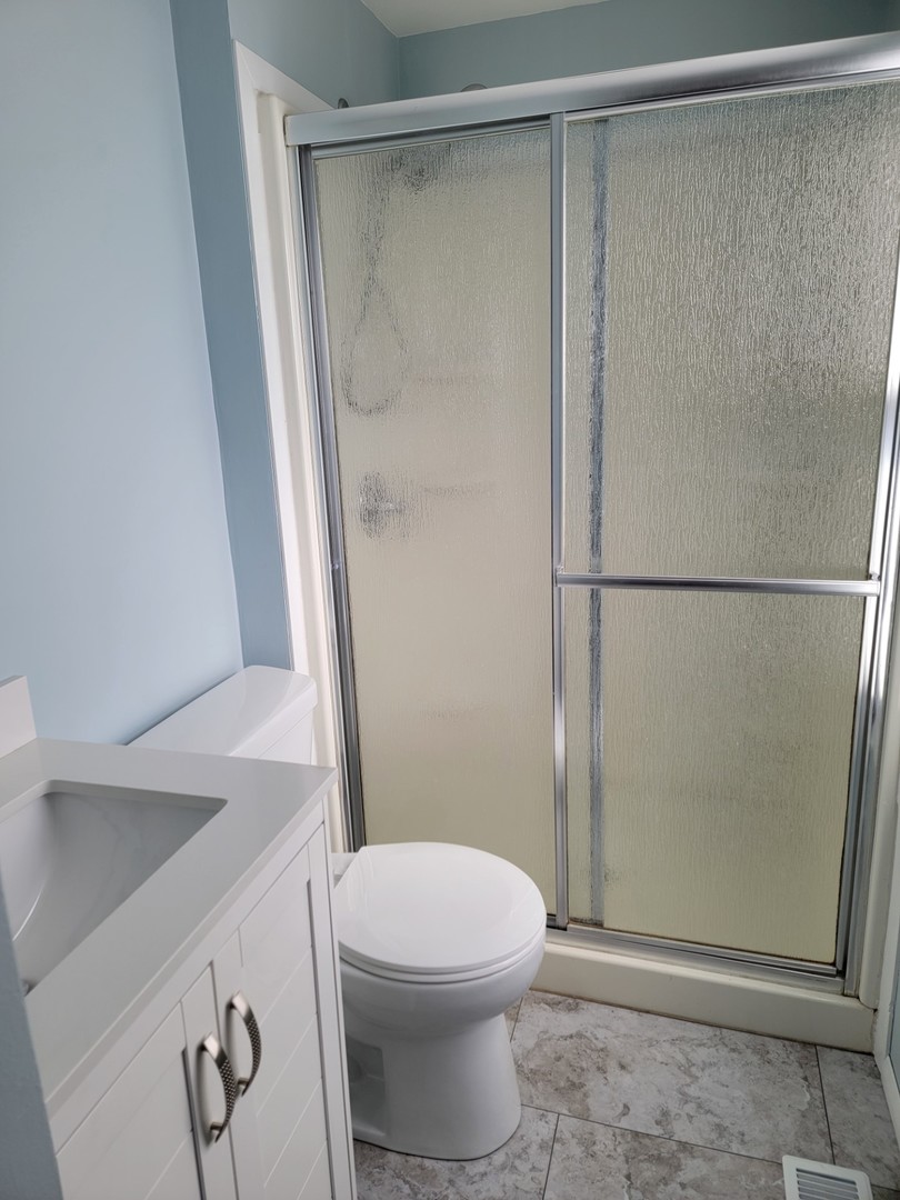 313 Dean Circle Bolingbrook, IL 60440 - Photo 11 of 15 a bathroom with a shower and a toilet
