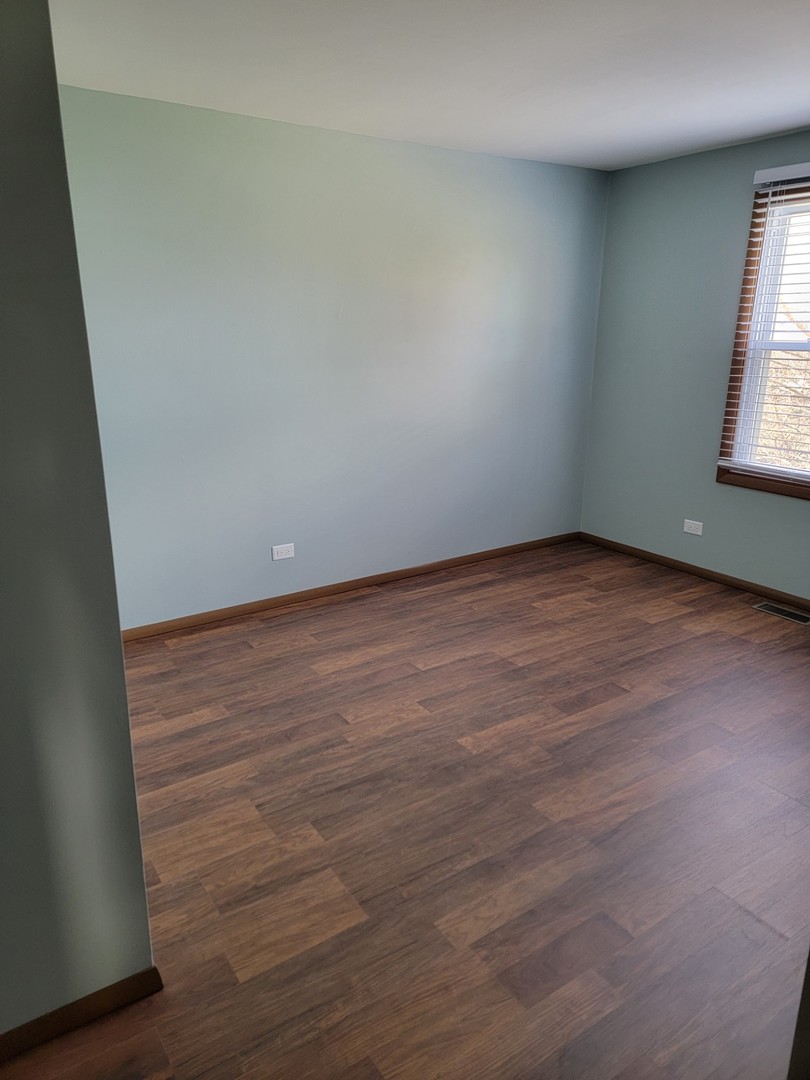 313 Dean Circle Bolingbrook, IL 60440 - Photo 12 of 15 an empty room with wooden floor and windows