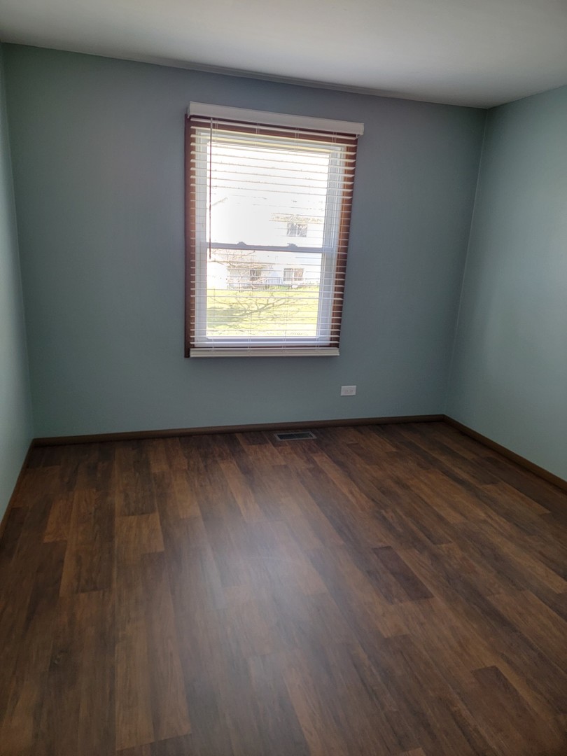 313 Dean Circle Bolingbrook, IL 60440 - Photo 13 of 15 an empty room with wooden floor and windows