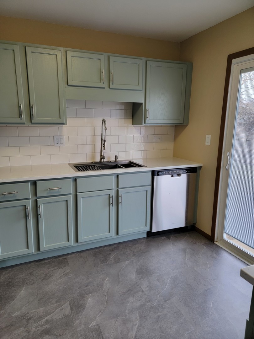 313 Dean Circle Bolingbrook, IL 60440 - Photo 2 of 15 a kitchen with stainless steel appliances granite countertop a sink a stove and a refrigerator