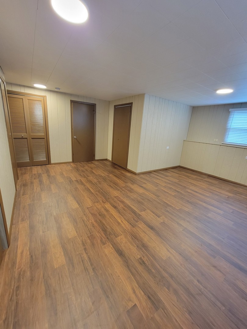 313 Dean Circle Bolingbrook, IL 60440 - Photo 7 of 15 a view of an empty room with wooden floor and a window