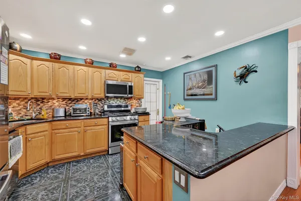 a kitchen with stainless steel appliances granite countertop a refrigerator and a sink
