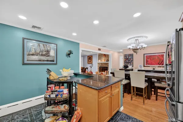 a kitchen with stainless steel appliances granite countertop a refrigerator and a stove top oven