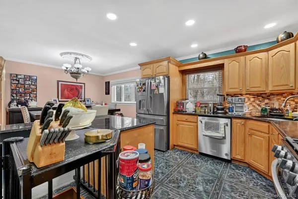 a view of a hallway with workspace and a refrigerator